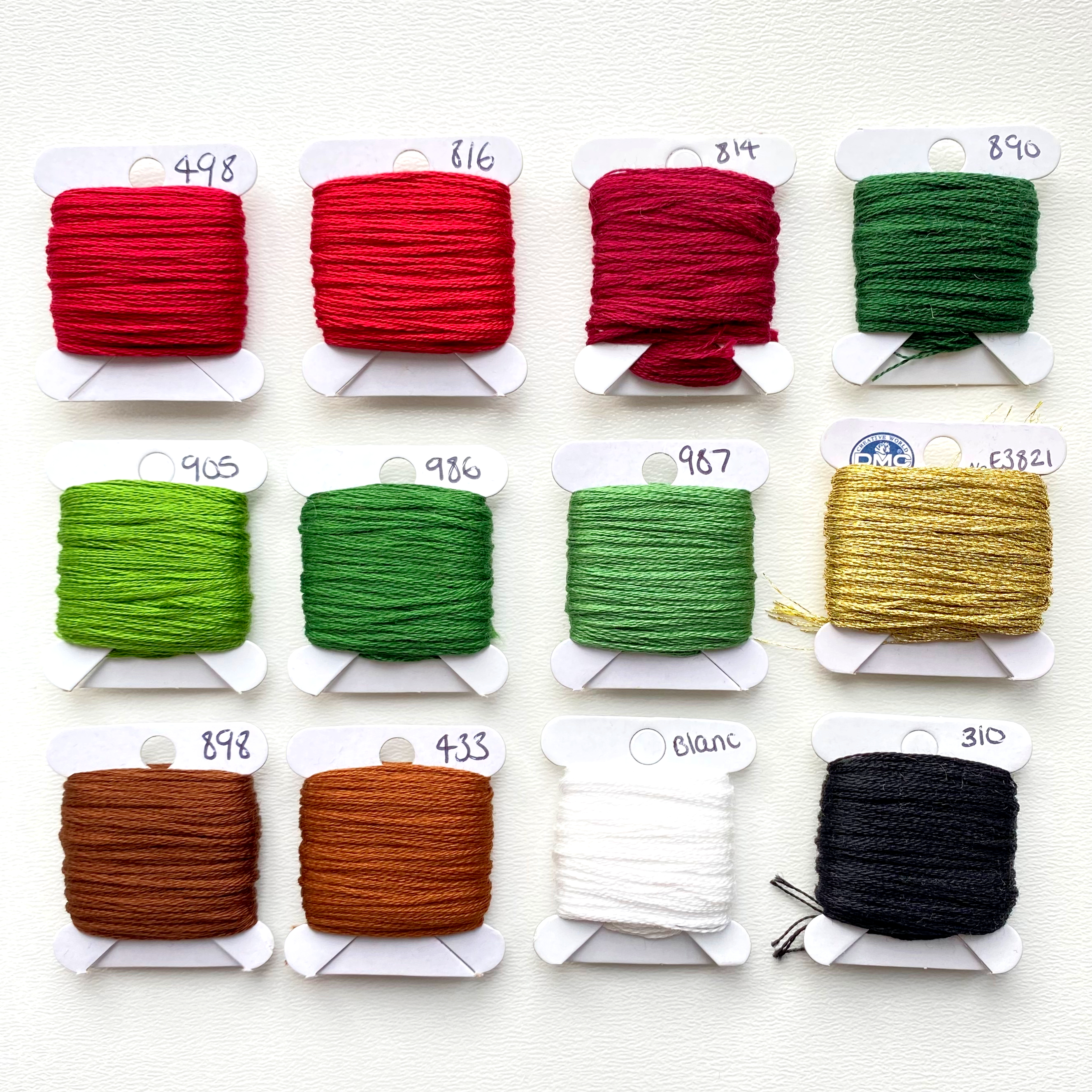 Embroidery threads on bobbins laid out