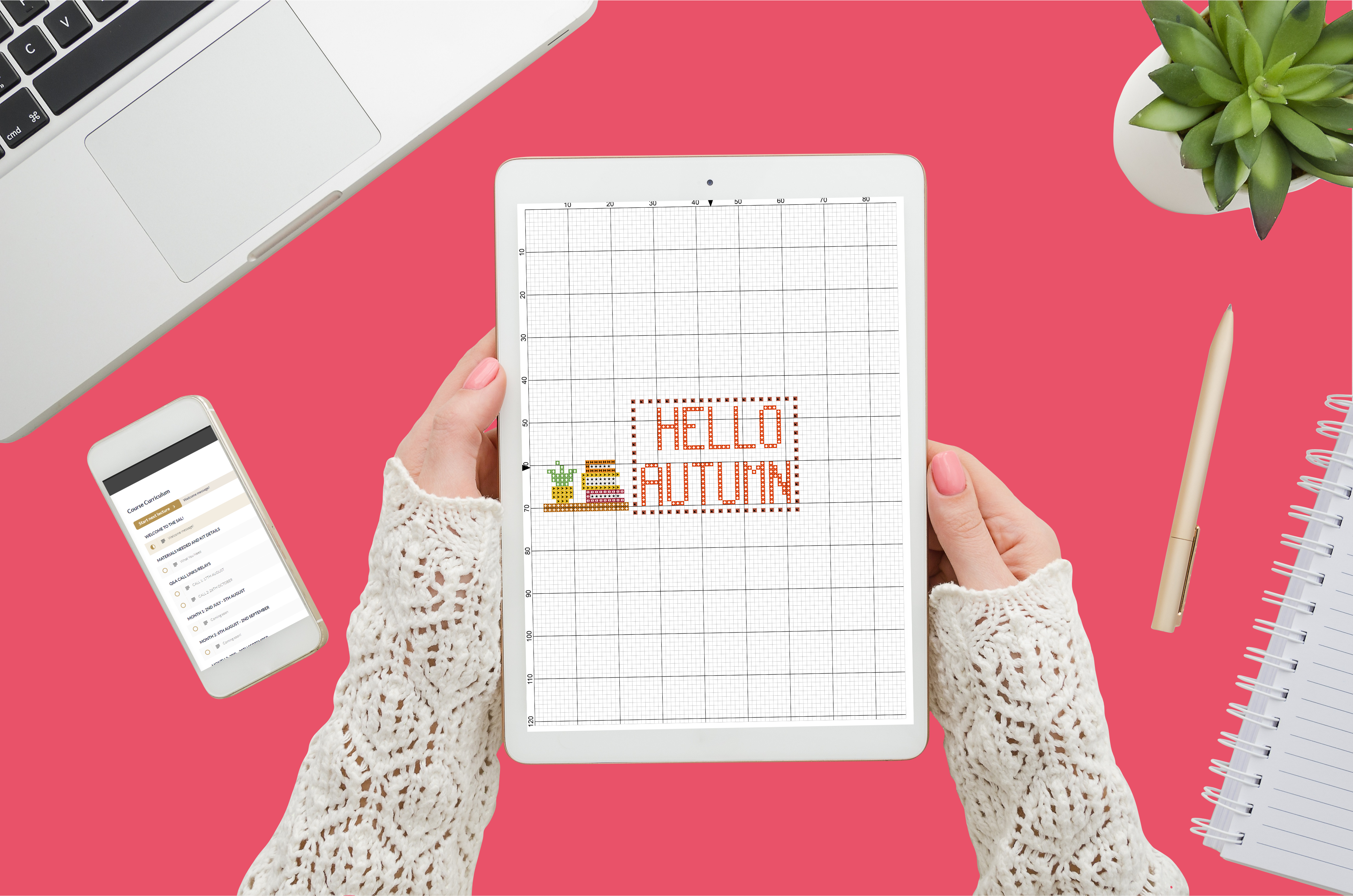hands holding tablet with small peek of hello autumn cross stitch pattern